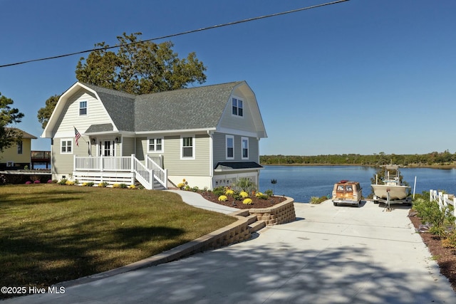 view of front of house featuring a front yard, a water view, and covered porch