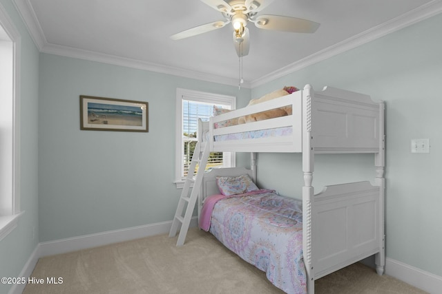 carpeted bedroom with ceiling fan and crown molding