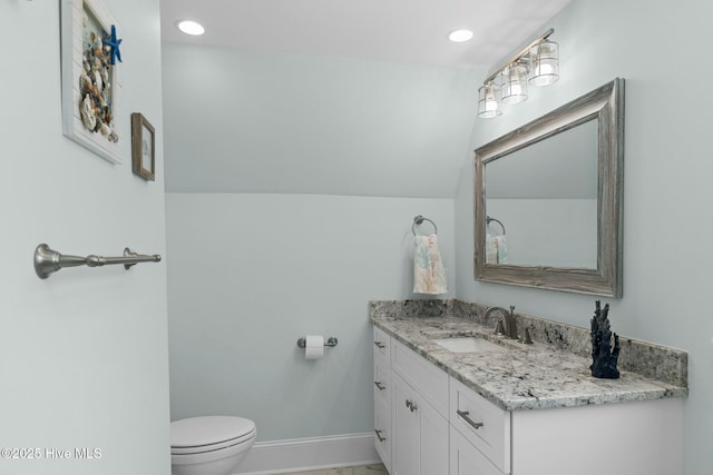 bathroom with vanity, toilet, and vaulted ceiling