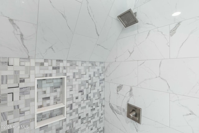 bathroom with tiled shower