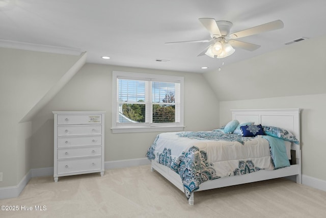 bedroom with ceiling fan, ornamental molding, light carpet, and vaulted ceiling