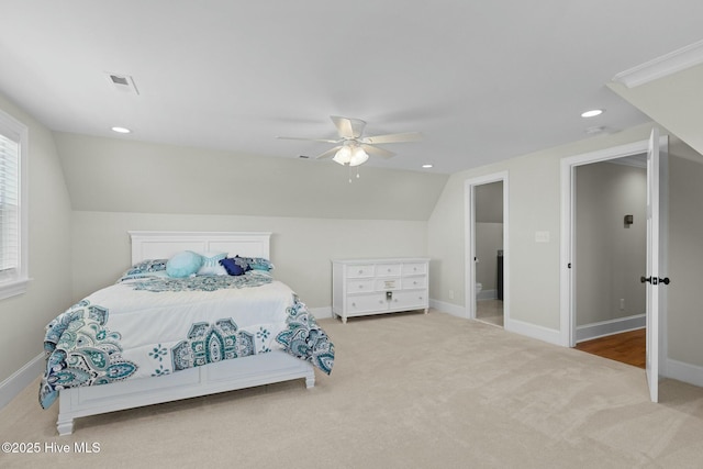 bedroom with ceiling fan, light colored carpet, and lofted ceiling