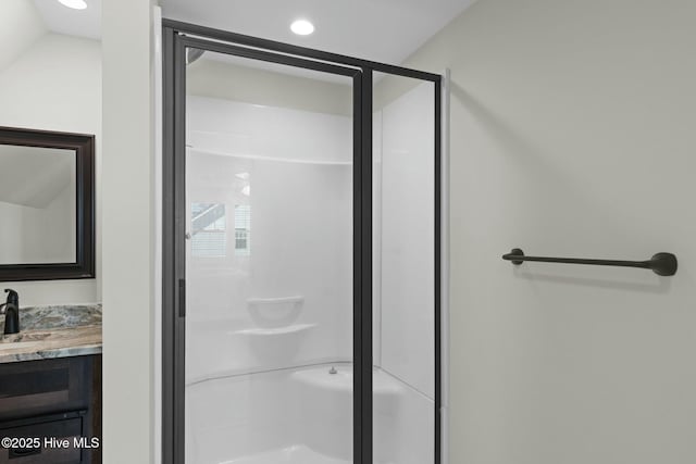 bathroom featuring vanity and a shower with shower door