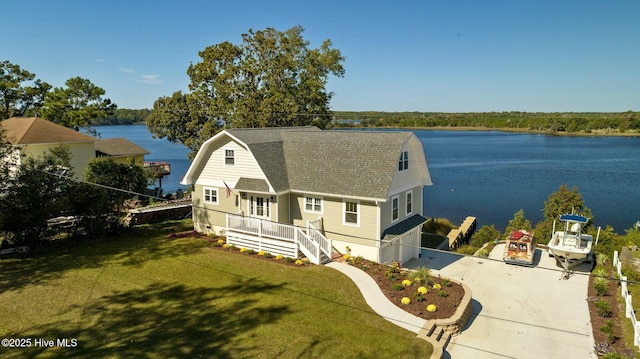 view of front of house featuring a water view, a front yard, and a garage