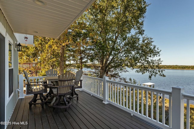 wooden terrace featuring a water view