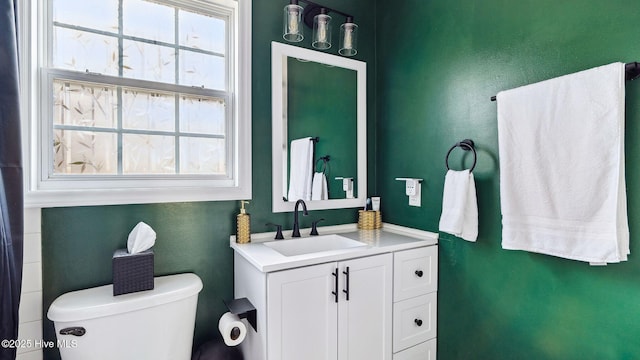 bathroom featuring toilet and vanity