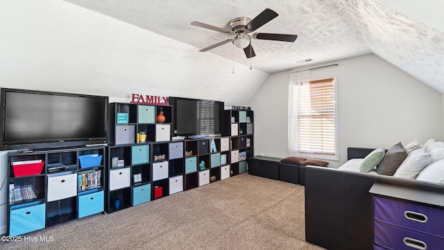 interior space featuring a textured ceiling, ceiling fan, lofted ceiling, and carpet floors