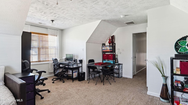 carpeted office with a textured ceiling and lofted ceiling