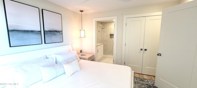 bedroom featuring hardwood / wood-style floors, ensuite bath, and ceiling fan