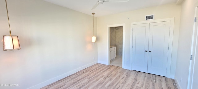 unfurnished bedroom with ceiling fan, light hardwood / wood-style floors, and a closet