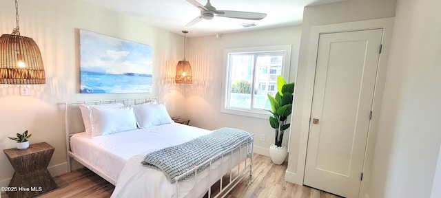 bedroom with light hardwood / wood-style floors and ceiling fan