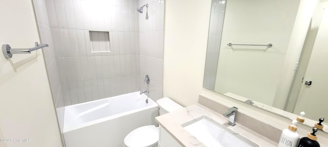 full bathroom featuring toilet, vanity, and tiled shower / bath combo