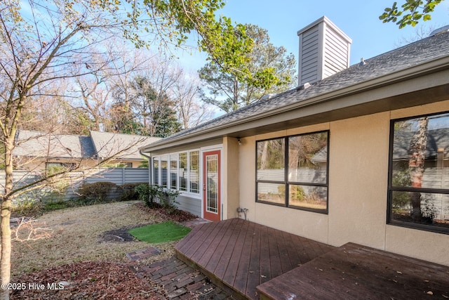 rear view of property featuring a deck