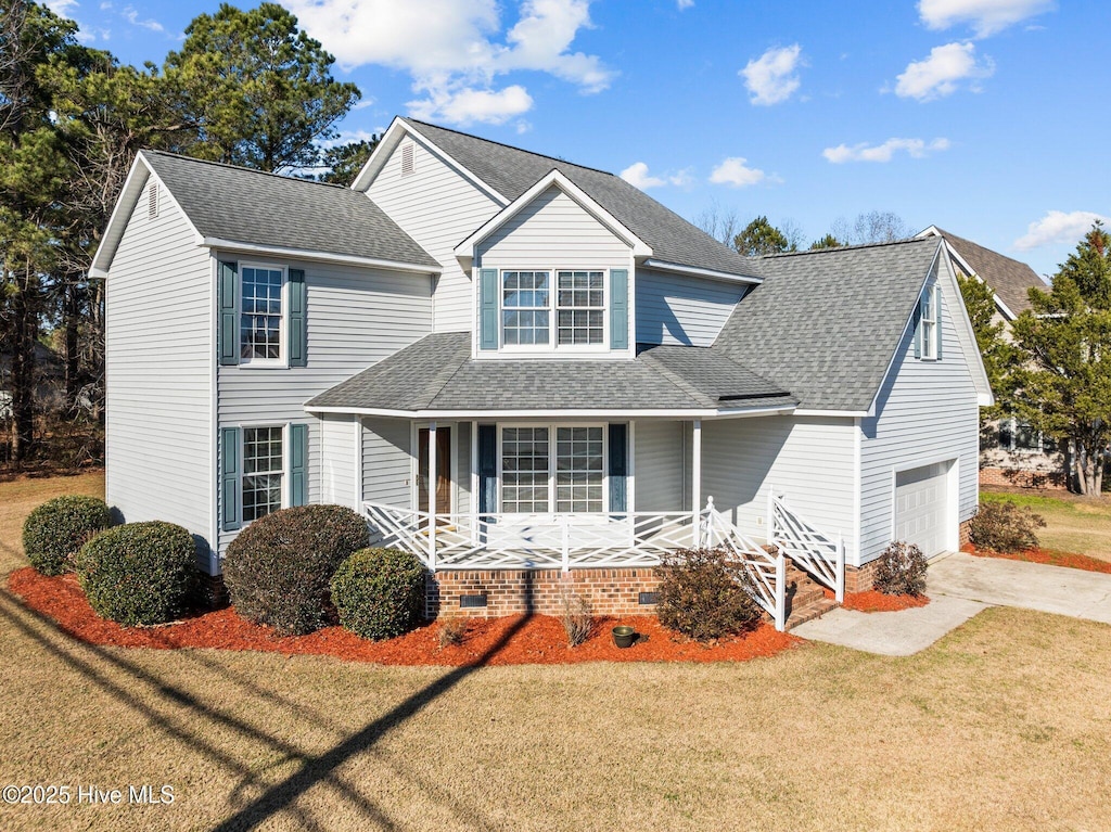 front facade with covered porch, a garage, and a front lawn