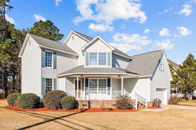 view of front of home featuring a garage, covered porch, and a front yard