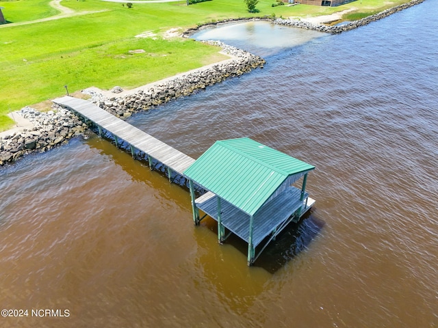 dock area with a yard and a water view