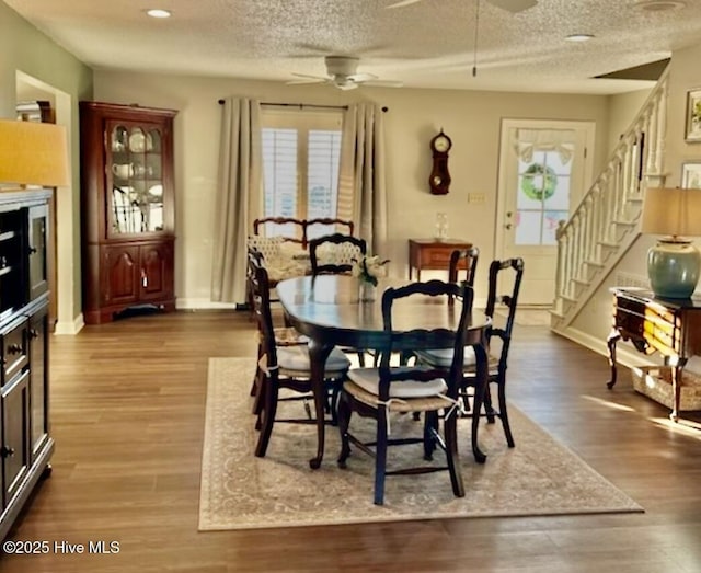 dining room featuring hardwood / wood-style flooring, a textured ceiling, and ceiling fan