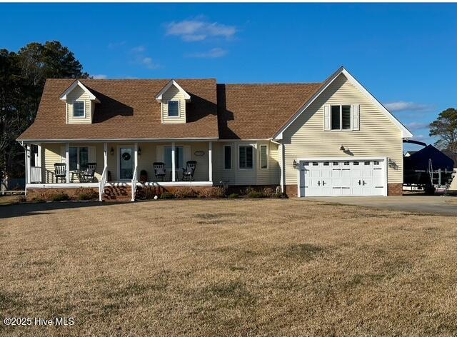 cape cod-style house with a front yard, a porch, and a garage