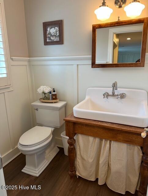 bathroom featuring hardwood / wood-style flooring, vanity, and toilet