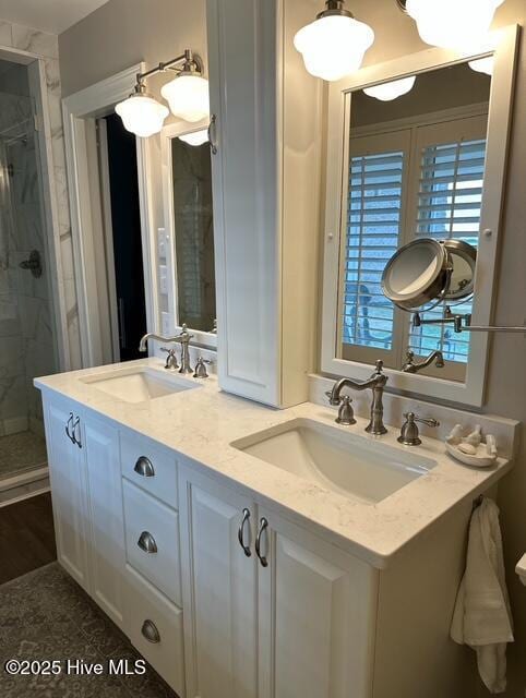 bathroom with an enclosed shower and vanity