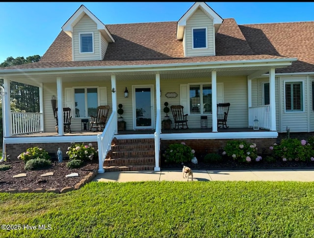 view of front of home featuring covered porch and a front yard