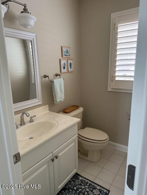 bathroom with vanity, toilet, and tile patterned flooring