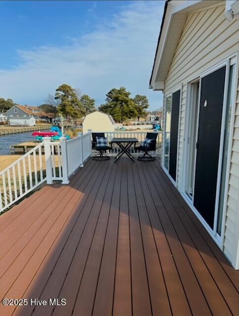 wooden deck featuring a water view