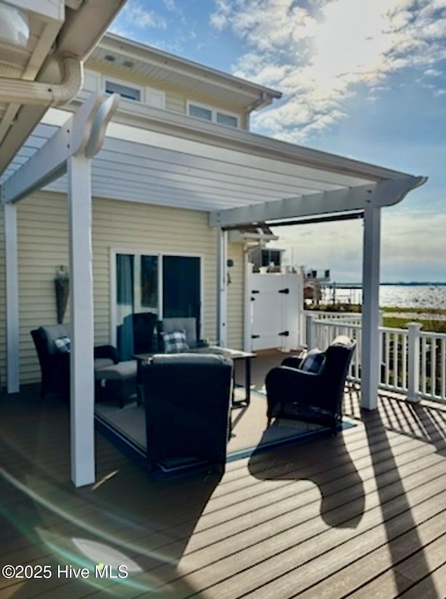 wooden deck featuring an outdoor living space and a pergola