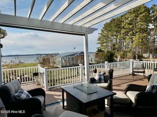 exterior space featuring a deck with water view, an outdoor hangout area, and a pergola