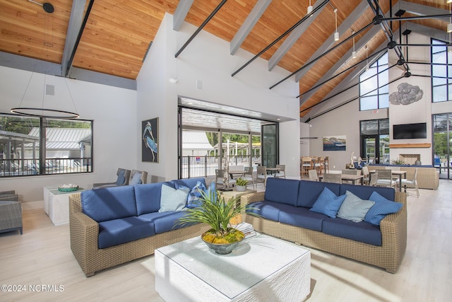 living room with light hardwood / wood-style floors, beam ceiling, wood ceiling, and high vaulted ceiling