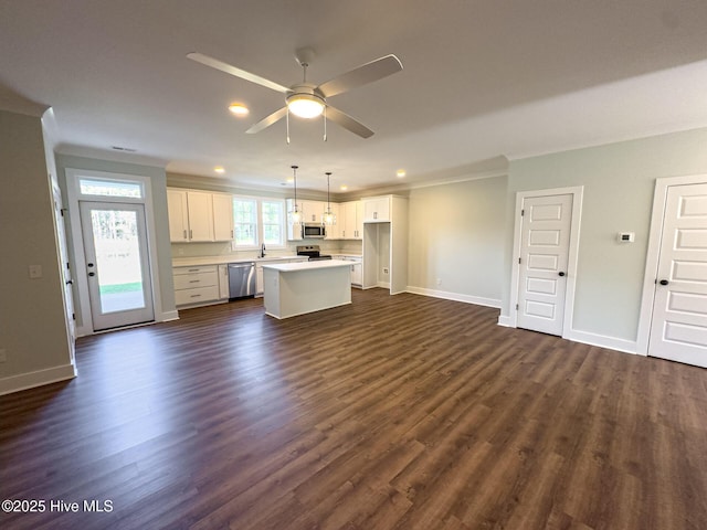 kitchen featuring hanging light fixtures, a kitchen island, dark hardwood / wood-style flooring, white cabinets, and appliances with stainless steel finishes