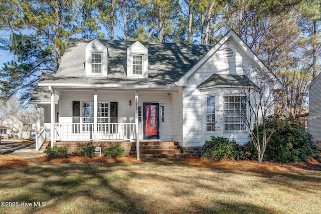 cape cod-style house featuring covered porch and a front yard