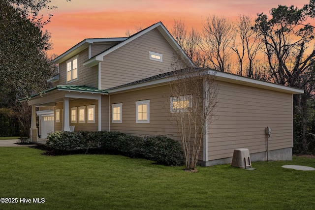 property exterior at dusk with a lawn