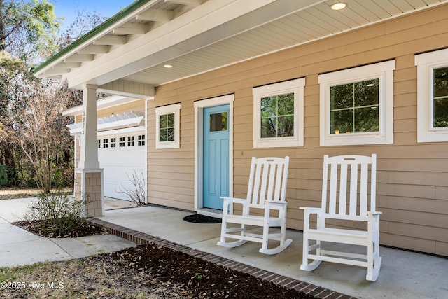 view of exterior entry featuring an attached garage