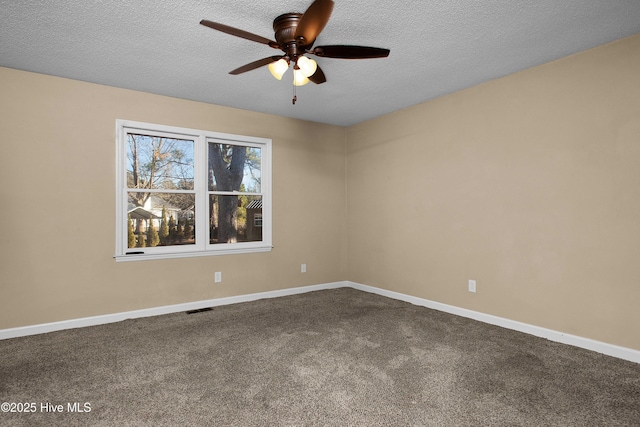 carpeted spare room with ceiling fan and a textured ceiling