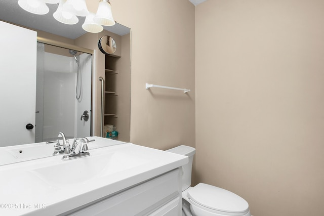 bathroom featuring vanity, toilet, and an enclosed shower