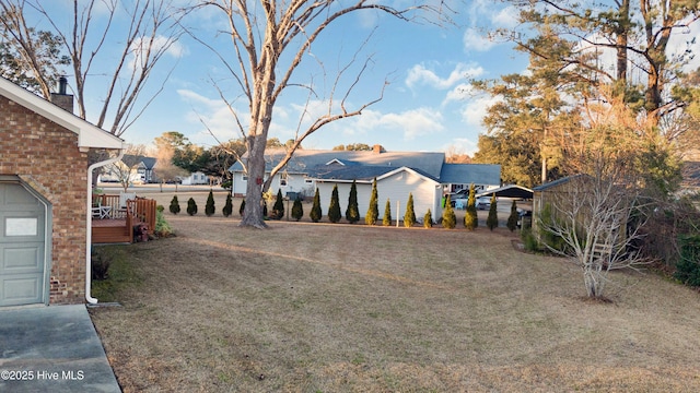 view of yard featuring a deck and a carport