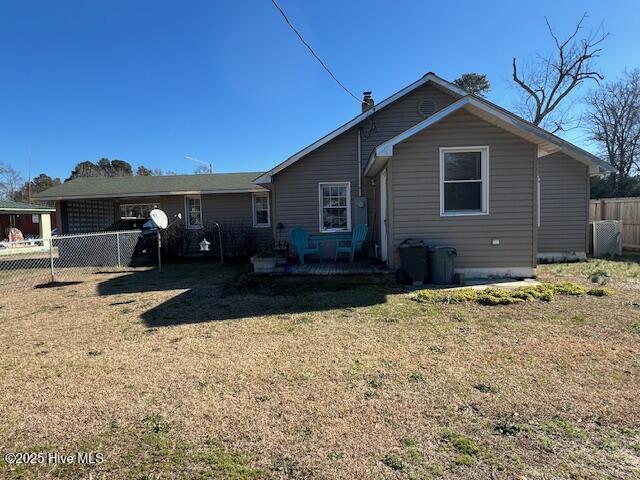 back of property with a patio area and a yard