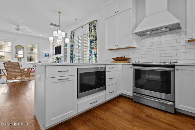 kitchen featuring white cabinets, electric range, built in microwave, tasteful backsplash, and custom range hood