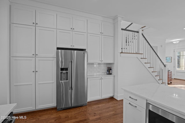 kitchen with dark wood-type flooring, wine cooler, decorative backsplash, stainless steel fridge, and white cabinetry