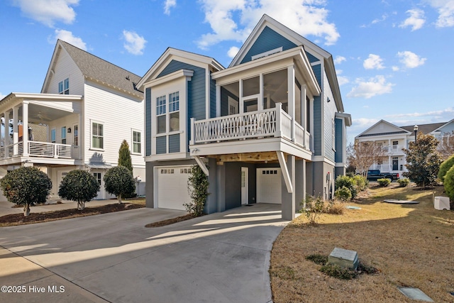 view of front of home with a carport, a sunroom, a garage, and a balcony