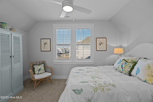 bedroom featuring a closet, ceiling fan, lofted ceiling, and light colored carpet