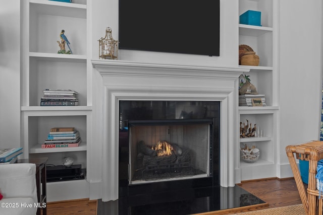 interior details featuring hardwood / wood-style floors and built in features