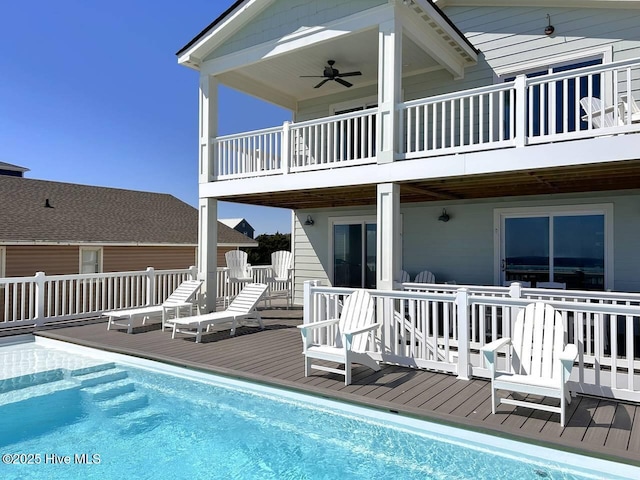 back of house with ceiling fan and a pool side deck