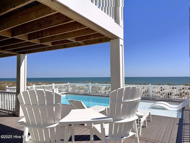 exterior space with a swimming pool with hot tub and a water view