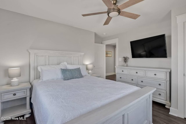 bedroom featuring ceiling fan and dark wood-type flooring