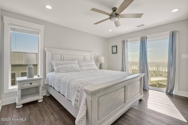 bedroom with ceiling fan, dark hardwood / wood-style floors, and access to exterior