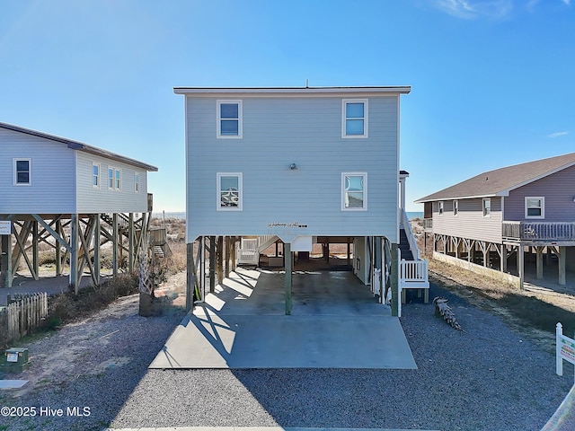 back of house with a carport