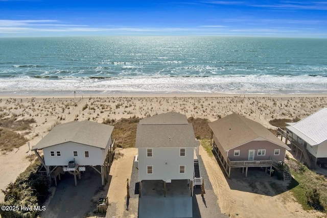 birds eye view of property with a beach view and a water view