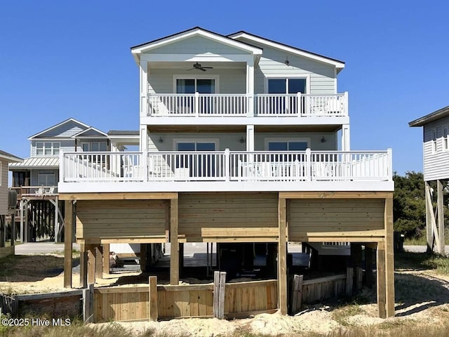 rear view of property featuring ceiling fan